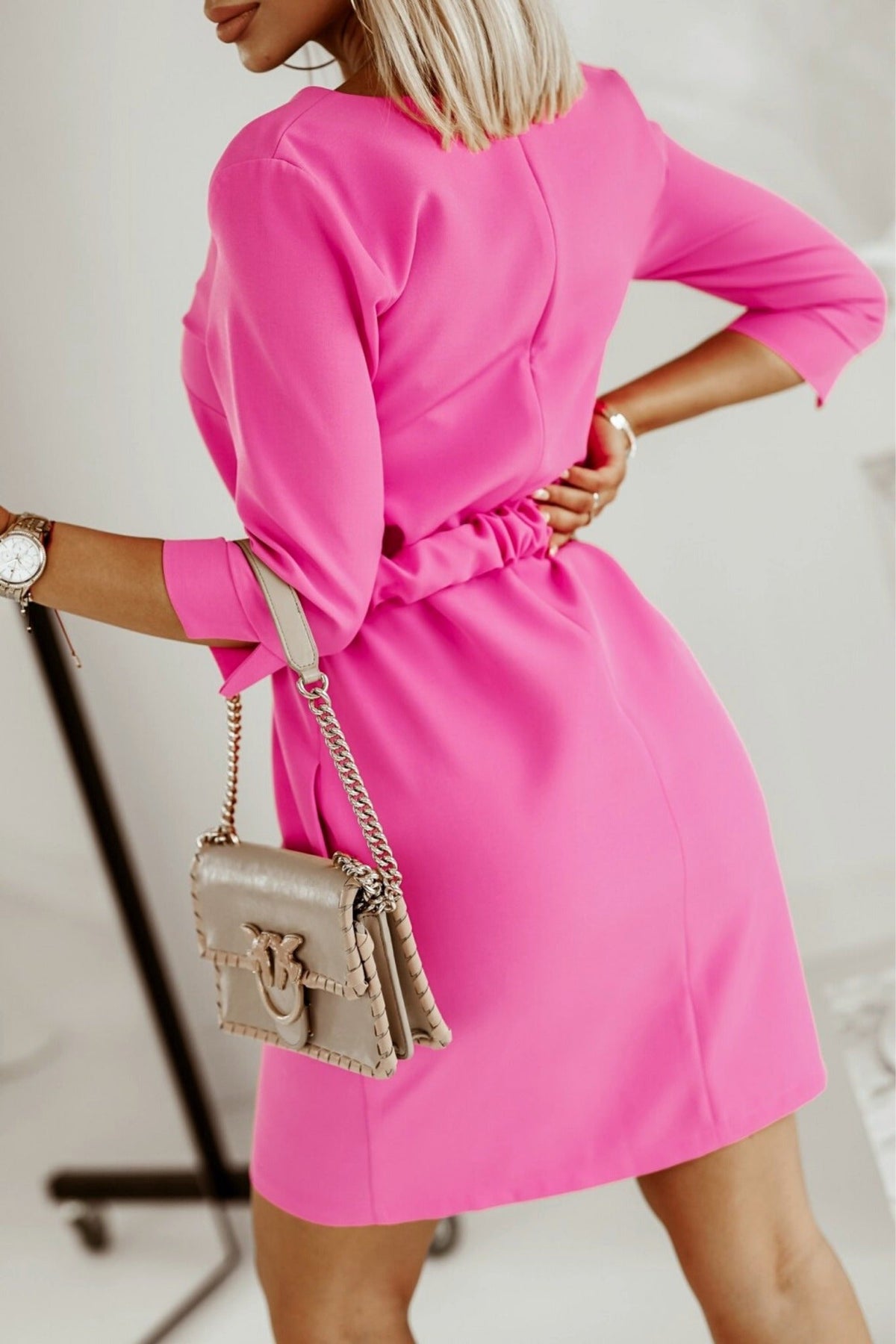 Abito casual fucsia Moda-Mania, linea dritta con cintura e fibbia dorata, tessuto leggero e dettagli eleganti.