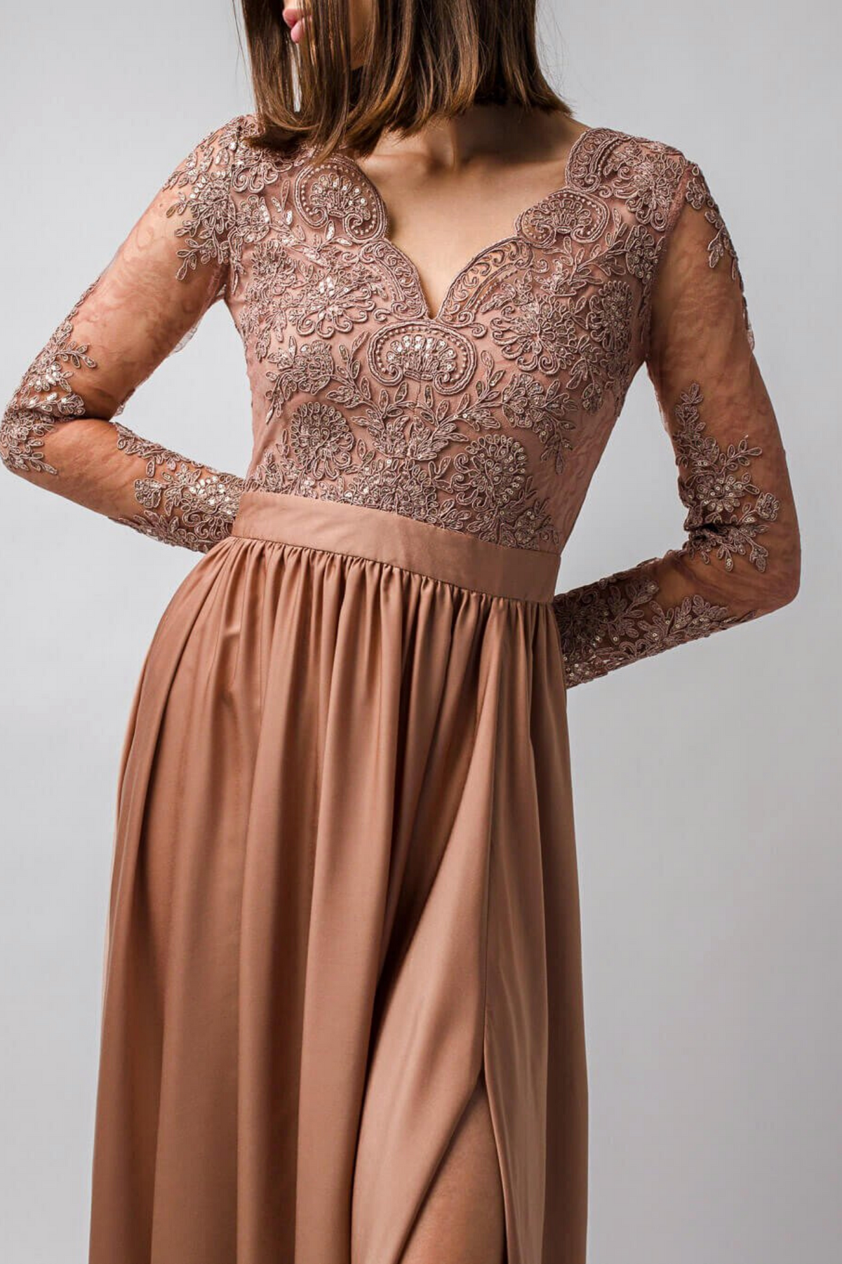 Abito lungo svasato dorato bronzo Moda-Mania con tessuto lucido, spacco laterale e corpetto in tulle ricamato, elegante e sofisticato.