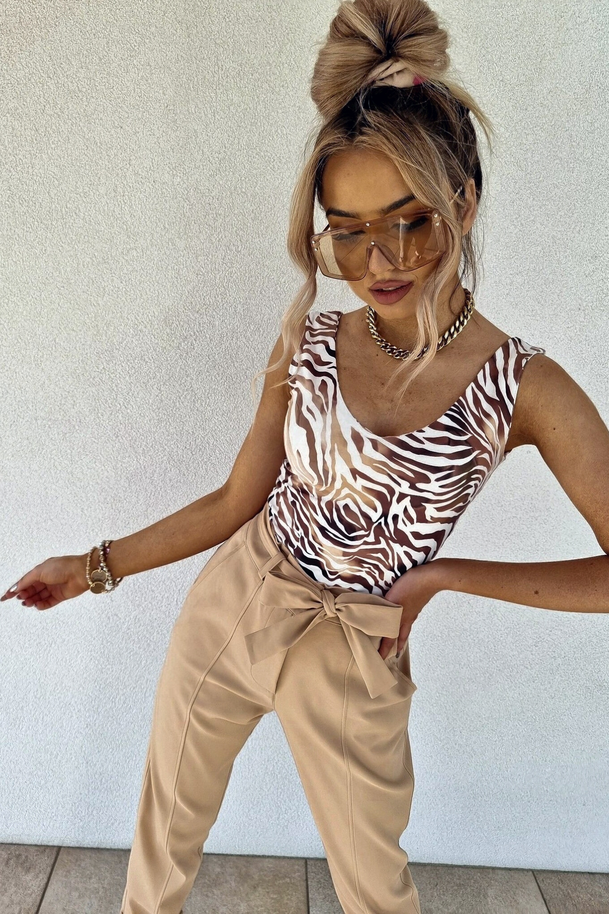 Canotta Moda-Mania con scollo a V in tessuto elasticizzato a fantasia zebrata su sfondo beige, dettaglio di stile e comfort