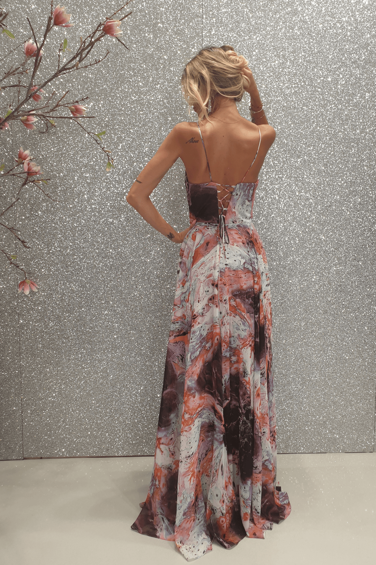 Abito lungo svasato in velo multicolore viola con fantasie, da Moda-Mania, con stringhe posteriori regolabili, ideale per occasioni eleganti.