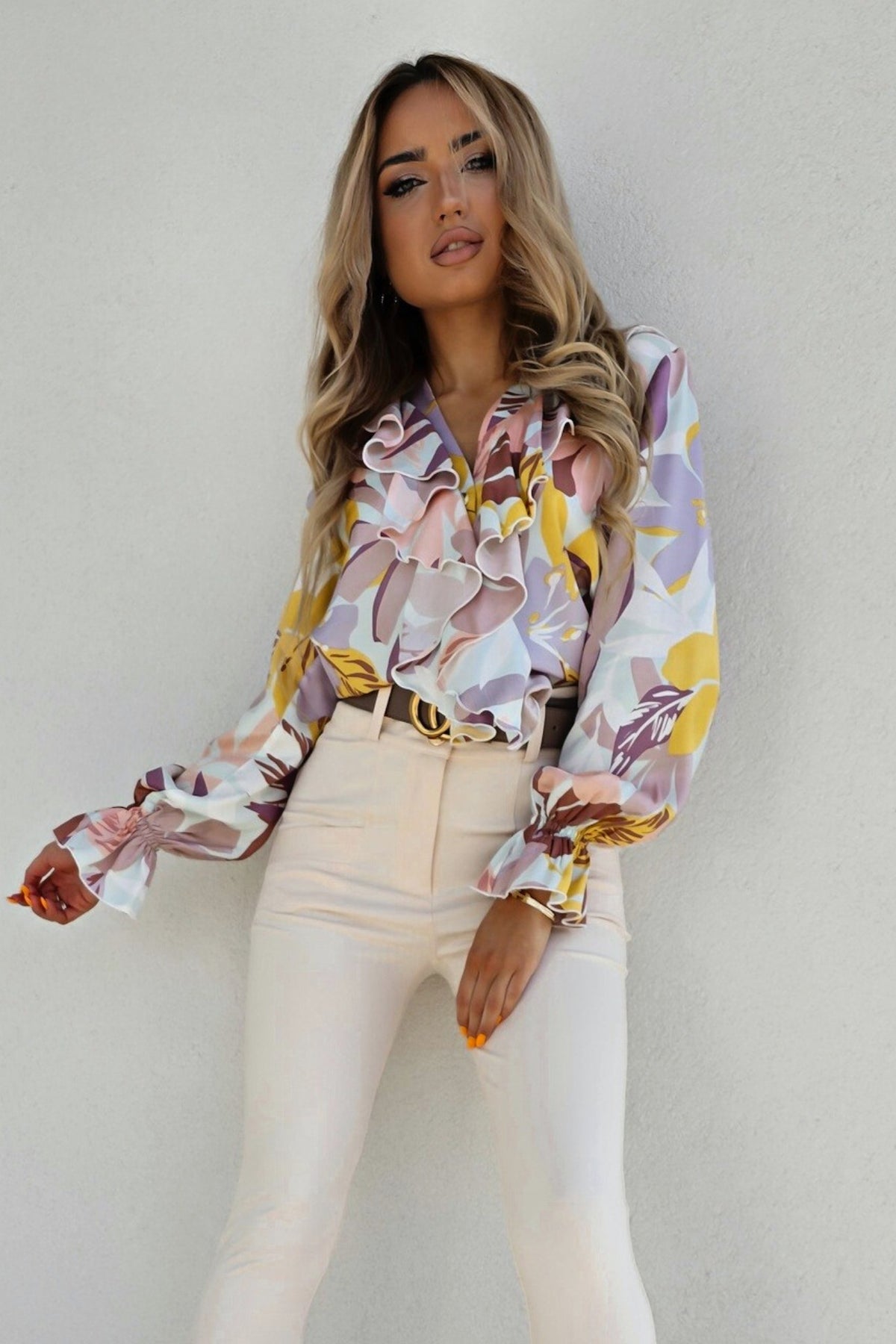 Camicia casual elegante Moda-Mania con fantasia floreale, scollo a V e dettagli in volants, tessuto leggero e femminile.