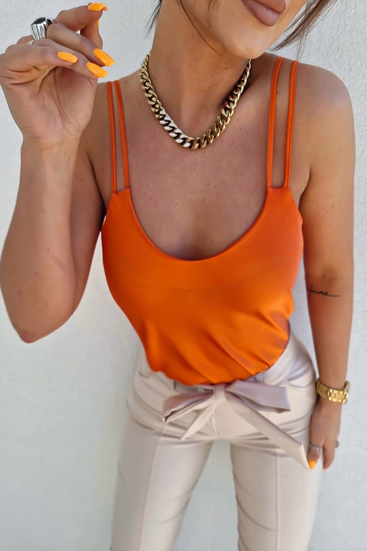 Canotta arancione Moda-Mania in tessuto satinato leggermente svasata con doppie spalline, elegante e versatile.