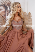 Abito lungo svasato dorato bronzo con spacco laterale e corpetto in tulle ricamato, moda-mania, eleganza e stile.