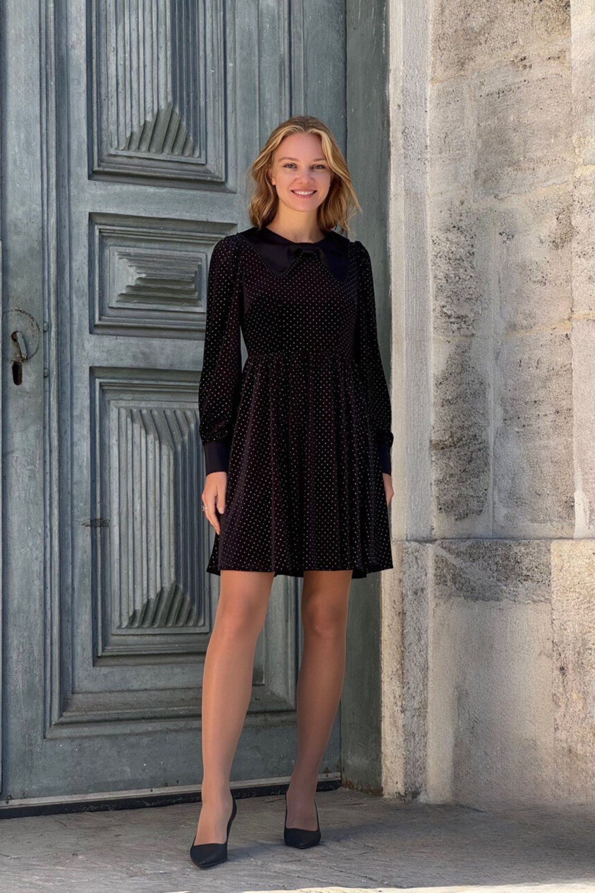 Abito midi nero svasato in velluto con pois argento, polsini e colletto nero in tessuto lucido, firmato Moda-Mania.