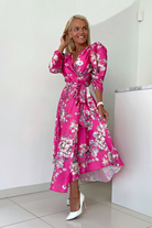 Abito midi fucsia svasato con fantasia floreale, maniche a sbuffo e allacciatura in vita, di Moda-Mania.