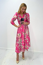 Abito midi fucsia svasato con fantasia floreale, maniche a sbuffo e allacciatura in vita, marca Moda-Mania.