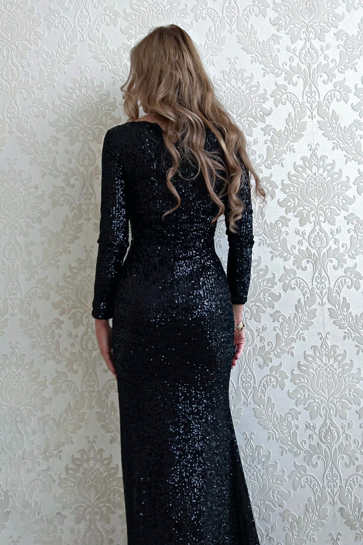 Abito lungo nero aderente in paillettes Moda-Mania con maniche lunghe e spacco laterale, vestito elegante e lucente.