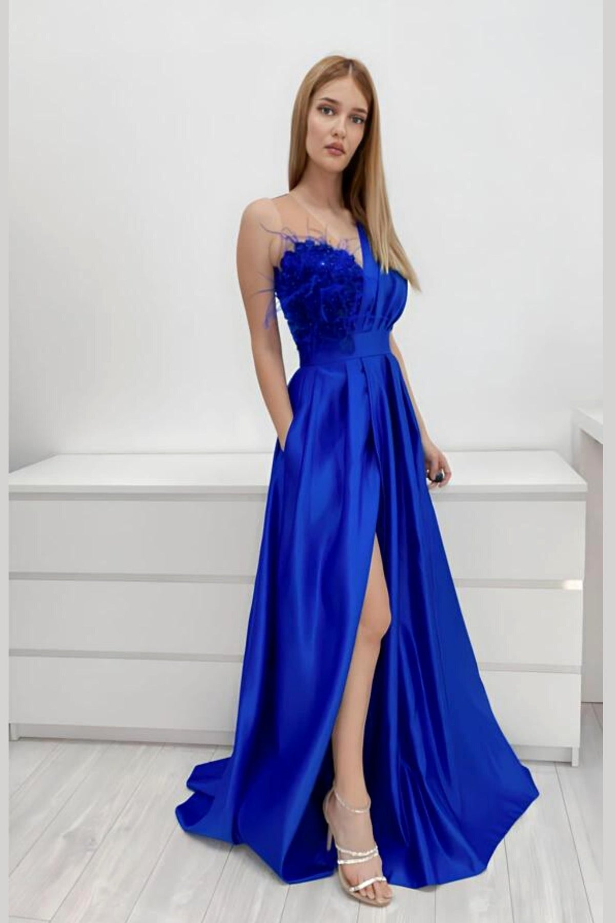 Abito lungo svasato blu elettrico Moda-Mania con spacco laterale, corpetto in perline, piume e fiori 3D.