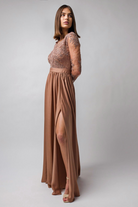 Abito lungo svasato dorato bronzo in tessuto lucido con spacco laterale e corpetto in tulle ricamato, firmato Moda-Mania.
