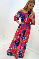 Abito lungo svasato estivo fucsia con fantasia floreale blu e scollo a barchetta in tessuto satinato, Moda-Mania.