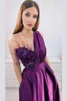 Abito lungo svasato viola prugna Moda-Mania con spacco laterale, corpetto in perline, piume e fiori 3D.