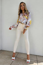 Camicia casual elegante Moda-Mania con fantasia floreale, scollo a V e dettagli di volants decorativi, tessuto leggero e raffinato.