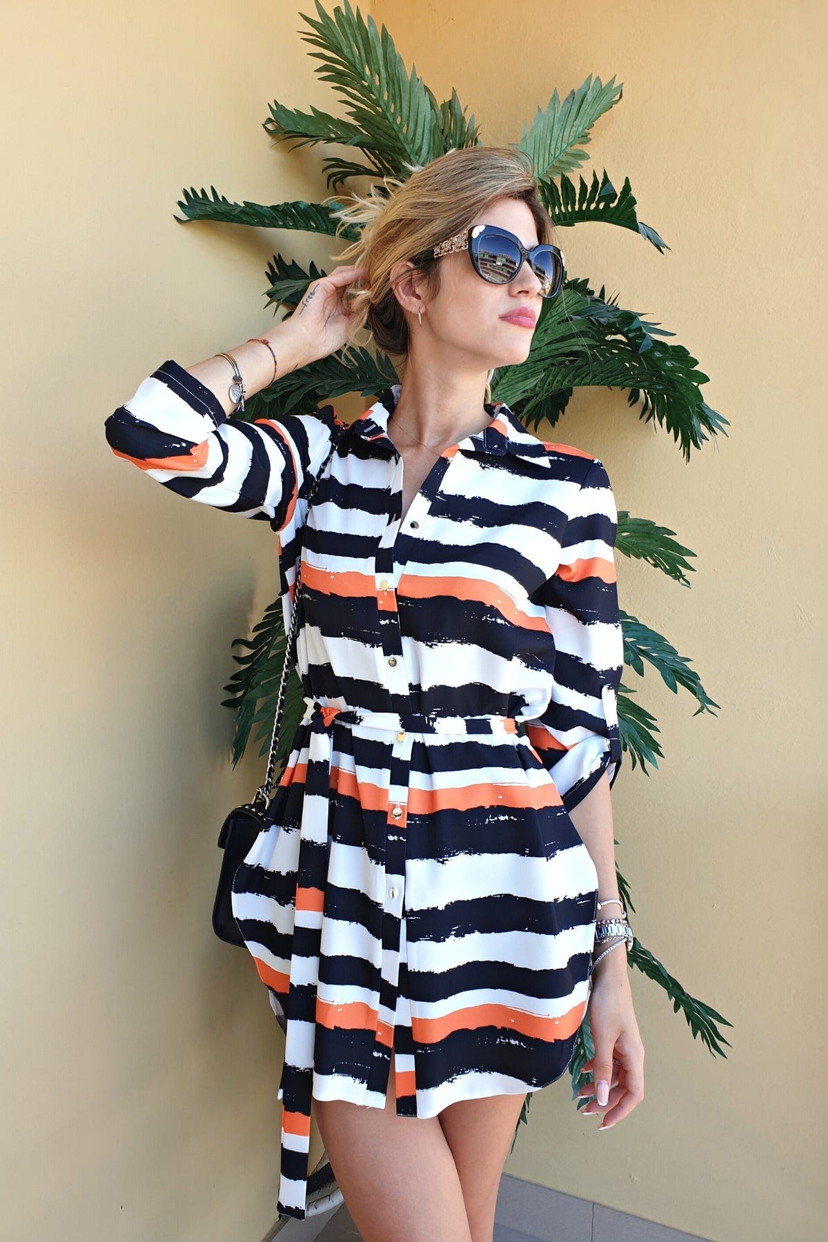 Camicia lunga bianca Moda-Mania con fantasia righe nere e arancioni, spacchi laterali e cinturino, abito corto elegante.
