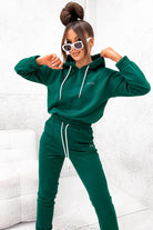 Completo sportivo Moda-Mania in cotone verde smeraldo con laccetti bianchi e stampa bianca del logo, ideale per attività sportive.