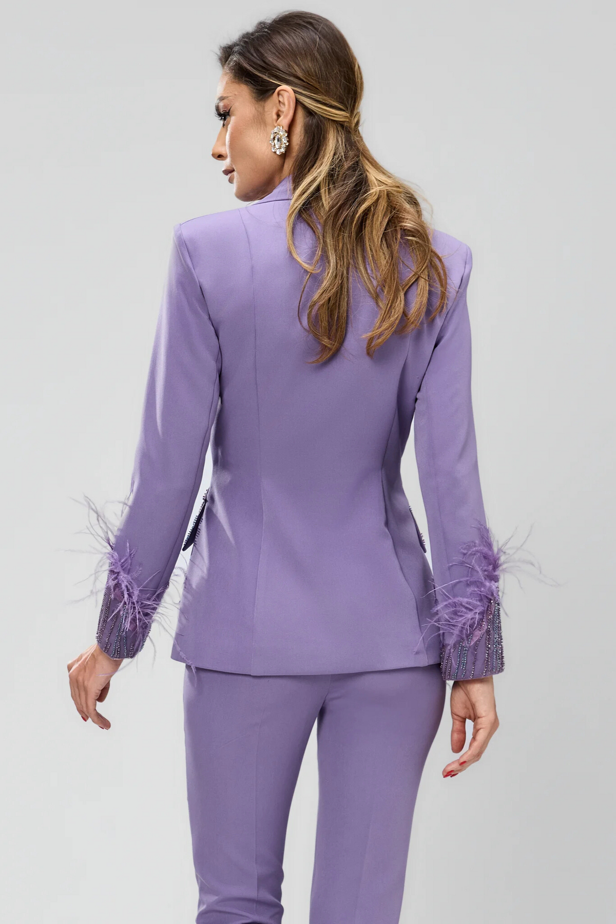 Completo tailleur Bby con giacca lilla impreziosita con piume e ricami in perline, pantaloni a sigaretta eleganti.