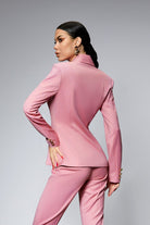 Completo tailleur rosa Bby con giacca doppiopetto e pantalone, accessoriato con bottoni metallici dorati, elegante e moderno.