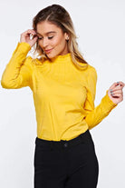 Camicia gialla Fofy a collo alto con maniche lunghe e polsini, dettagli di arricciatura e bottoni dorati, vista frontale.