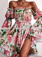 Abito estivo corto Moda-Mania con fantasia floreale verde e rosa, apertura posteriore e maniche lunghe larghe, stile femminile.