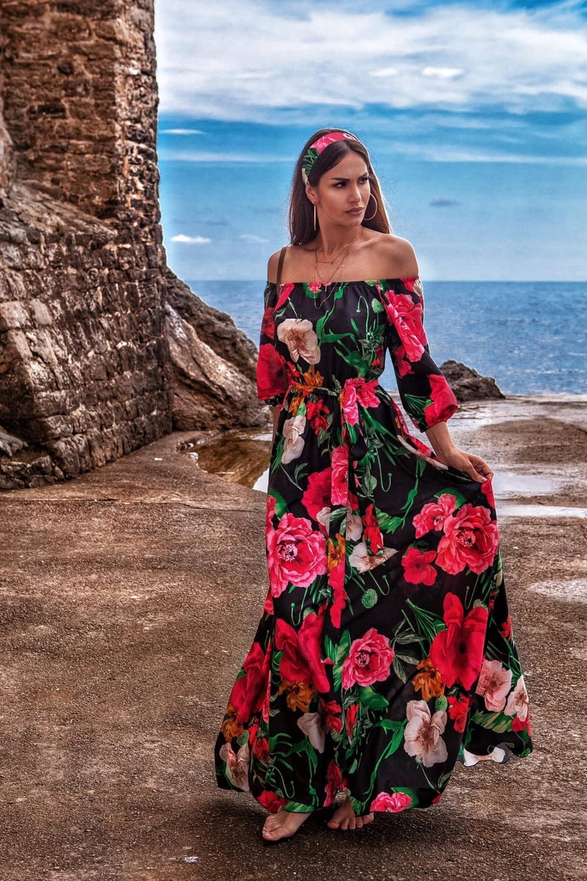 Abito lungo svasato estivo nero con fantasia floreale, scollo a barchetta in tessuto satinato, brand Moda-Mania.