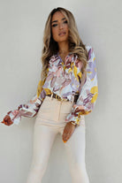 Camicia casual elegante Moda-Mania con fantasia floreale, scollo a V e dettagli in volants, tessuto leggero e femminile.