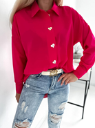 Camicia oversize magenta fucsia Moda-Mania con bottoni decorativi dorati a forma di cuore, vestibilità ampia e lunga.