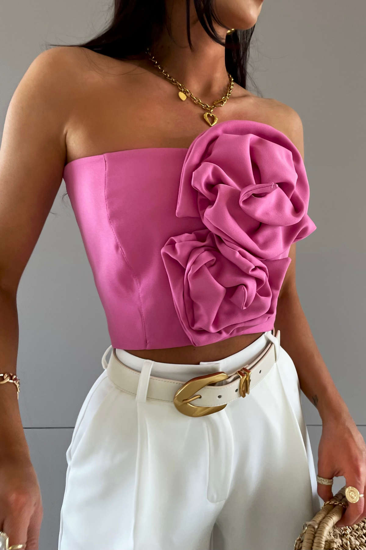 Corsetto crop top rosa pink a fascia con accessori e due fiori in tessuto, top moda Mania in stile femminile e raffinato.