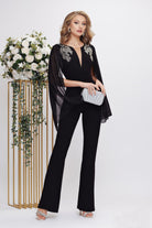 Salopette elegante nera Fofy, aderente ed elasticizzata con maniche aperte e dettagli argento sulle spalle.