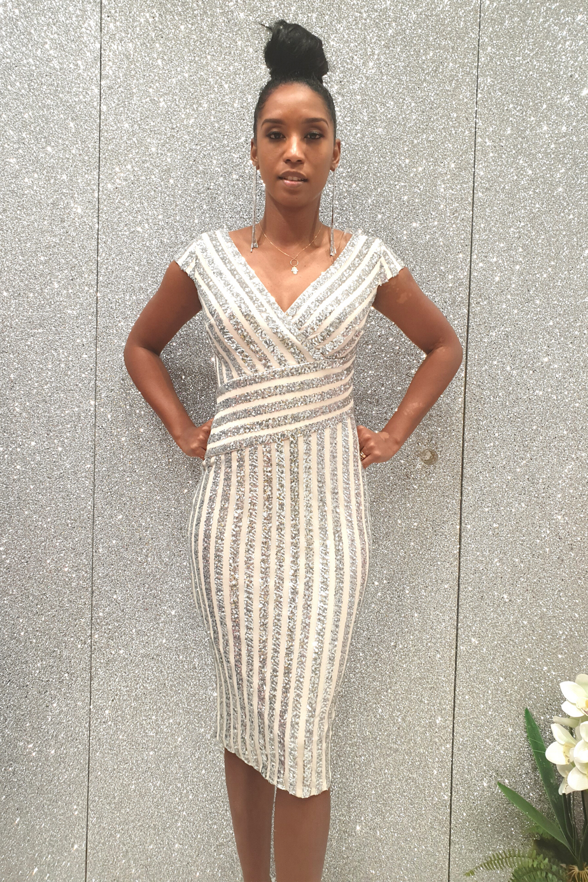 Abito a tubino Moda Mania bianco con fantasia righe a paillettes grigio argento, profondo scollo a V, maniche tre quarti.