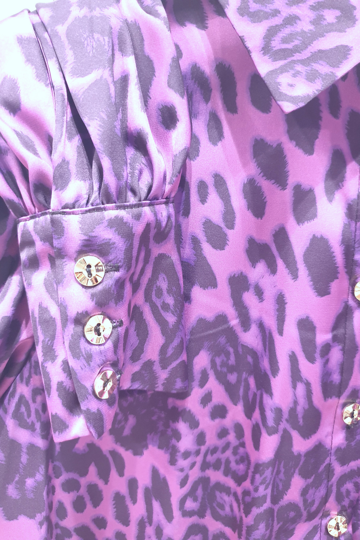 Camicia elegante a fantasia leopardata viola Moda-Mania con maniche a sbuffo e bottoni gioiello, dettaglio di stile raffinato.