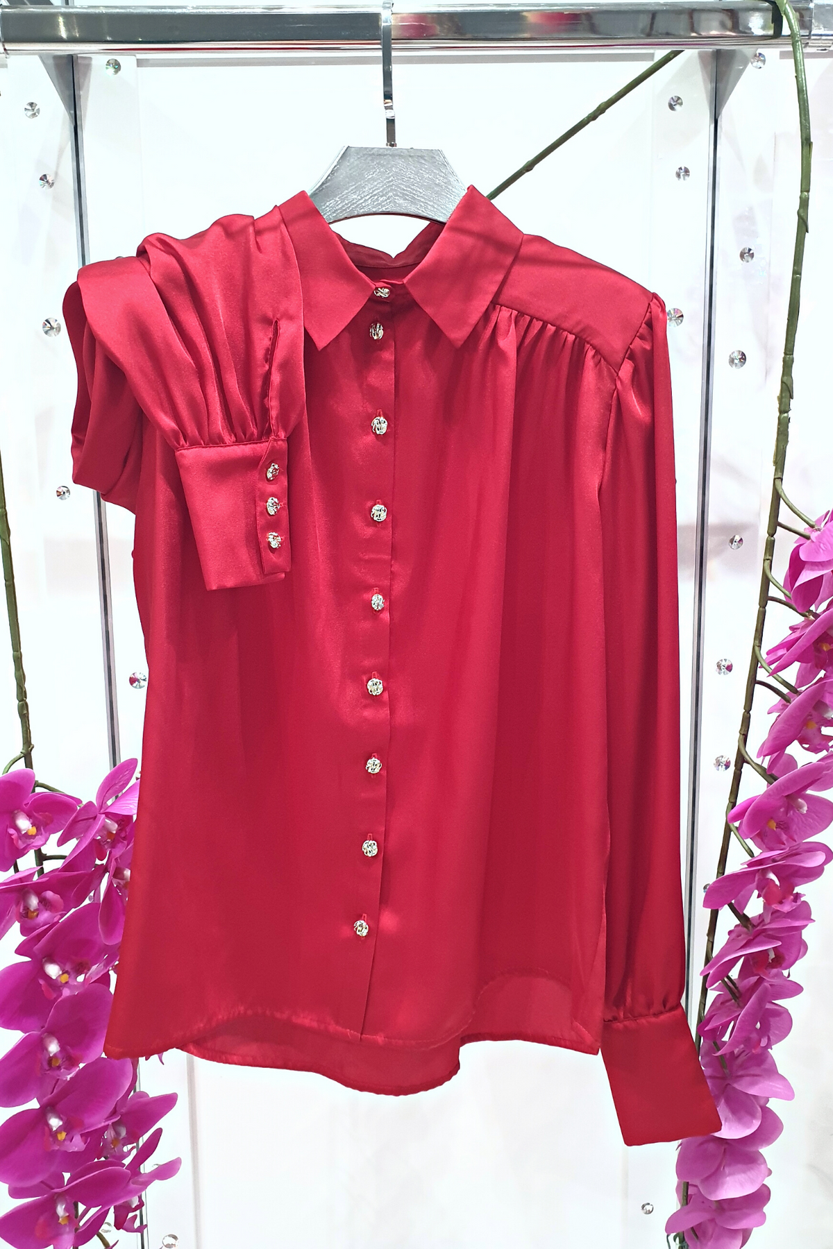 Camicia elegante rossa Moda-Mania in tessuto satinato con maniche a sbuffo e bottoni gioiello bianchi, vista frontale.